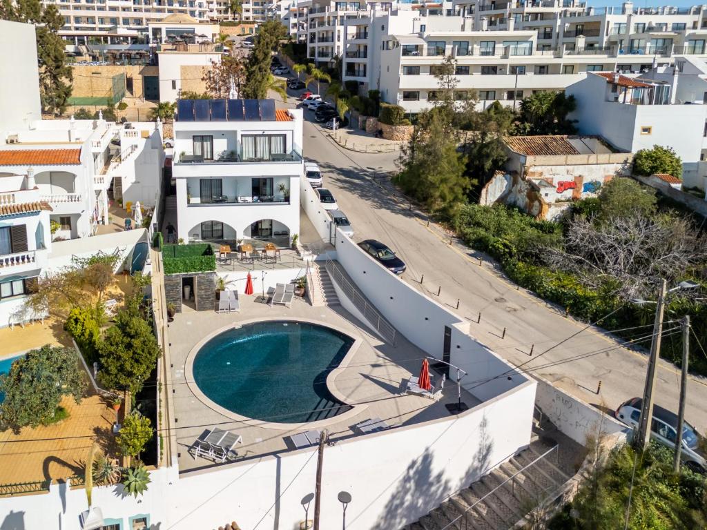 an aerial view of a building with a swimming pool at Malpique Guest House & Jacuzzi in Albufeira