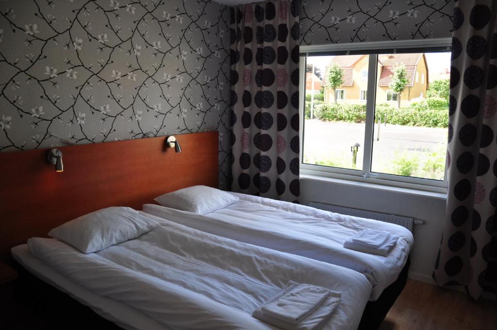 Postel nebo postele na pokoji v ubytování Arena Hotell