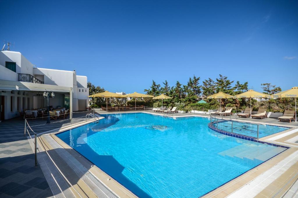 a large swimming pool with blue water at Astir Of Naxos in Naxos Chora