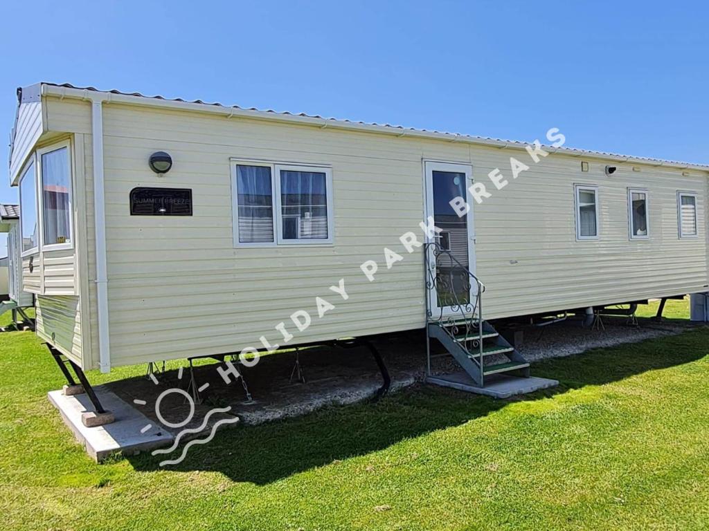 a mobile home with a staircase in a yard at Homely 3 bed @ Seal Bay (Bunn Leisure) Selsey in Selsey