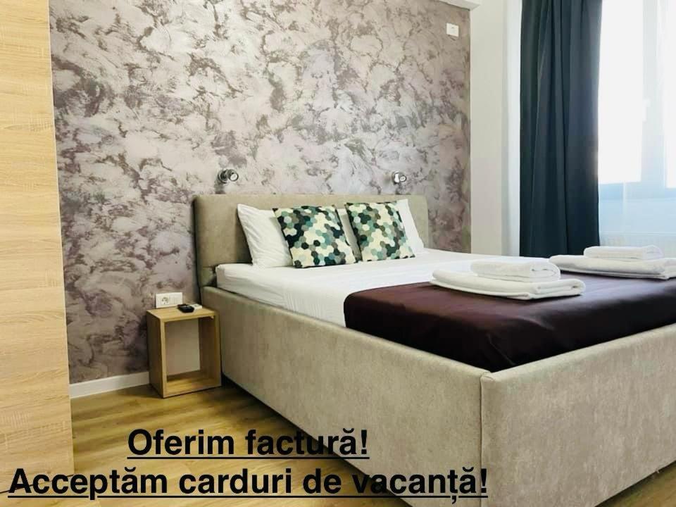 a bedroom with a bed with a couch in it at Happy Apartments Mamaia Nord -2 Dormitoare in Mamaia Sat/Năvodari