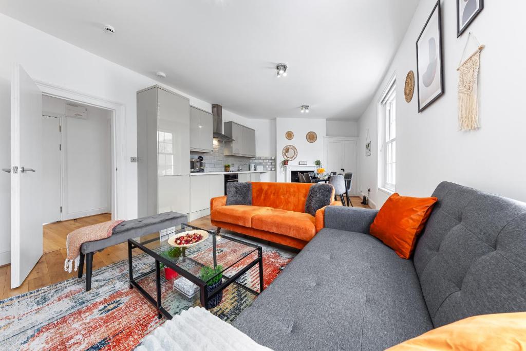 ein Wohnzimmer mit einem Sofa und einem Tisch in der Unterkunft Stunning apartment in Kings Cross sleeps 10 in London