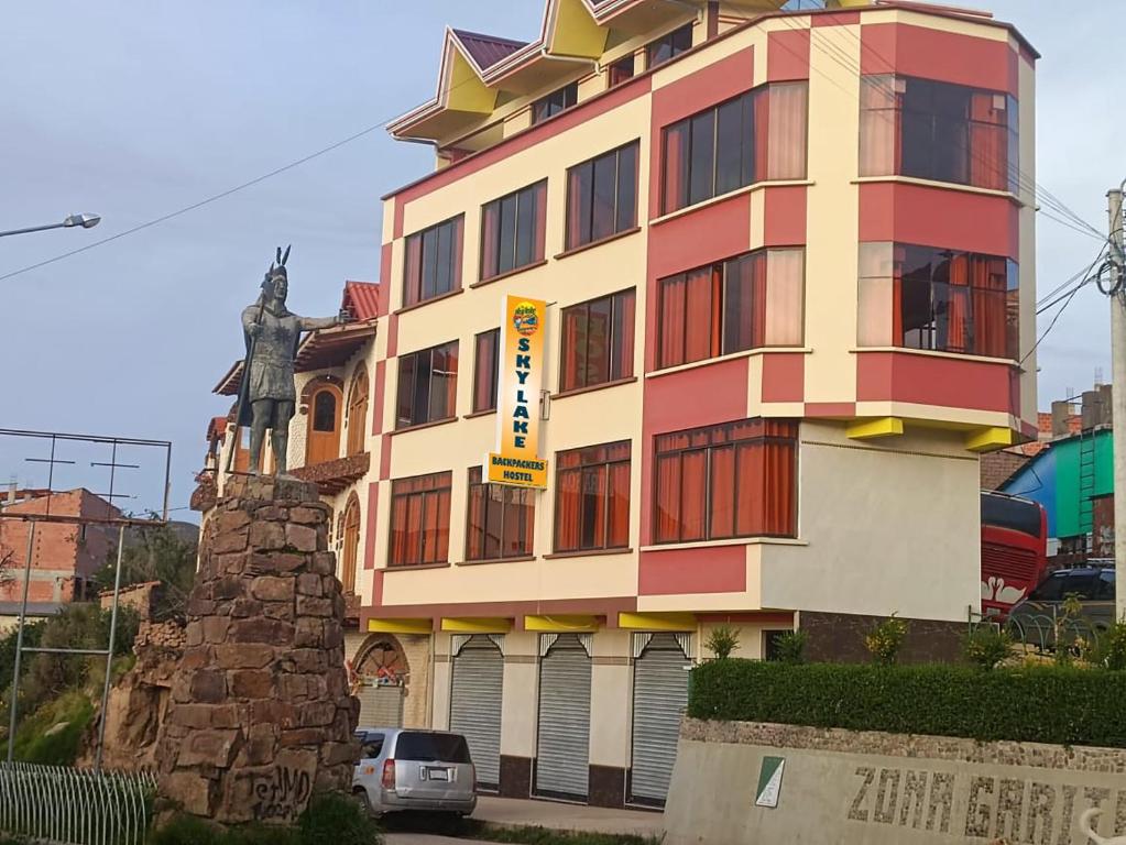 a building with a sign on the side of it at Sky Lake Backpackers Hostel in Copacabana