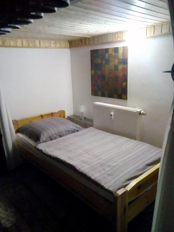 a bed in a room with a painting on the wall at Brachelen in Hückelhoven