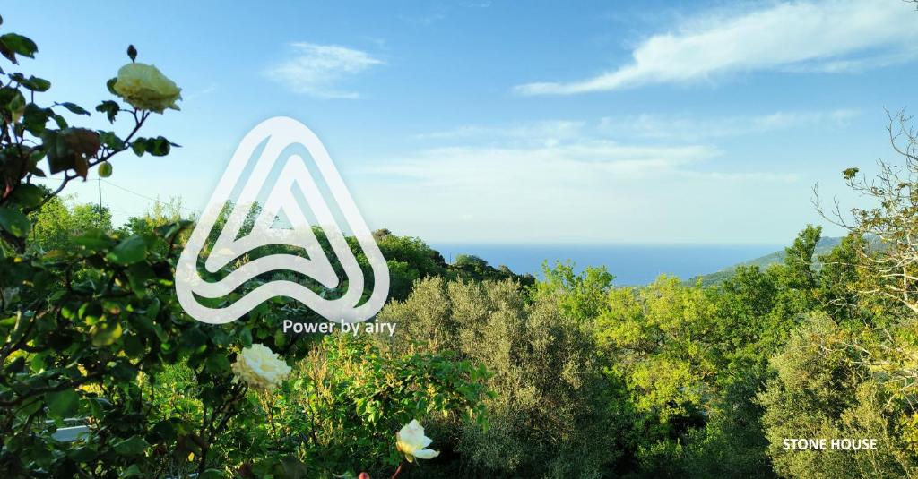 aana logo in the middle of a forest of trees at stone house / Evdilos Icaria (-50%) in Akamatra