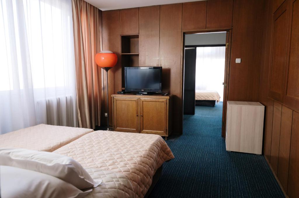 Postel nebo postele na pokoji v ubytování Hotel Slavija
