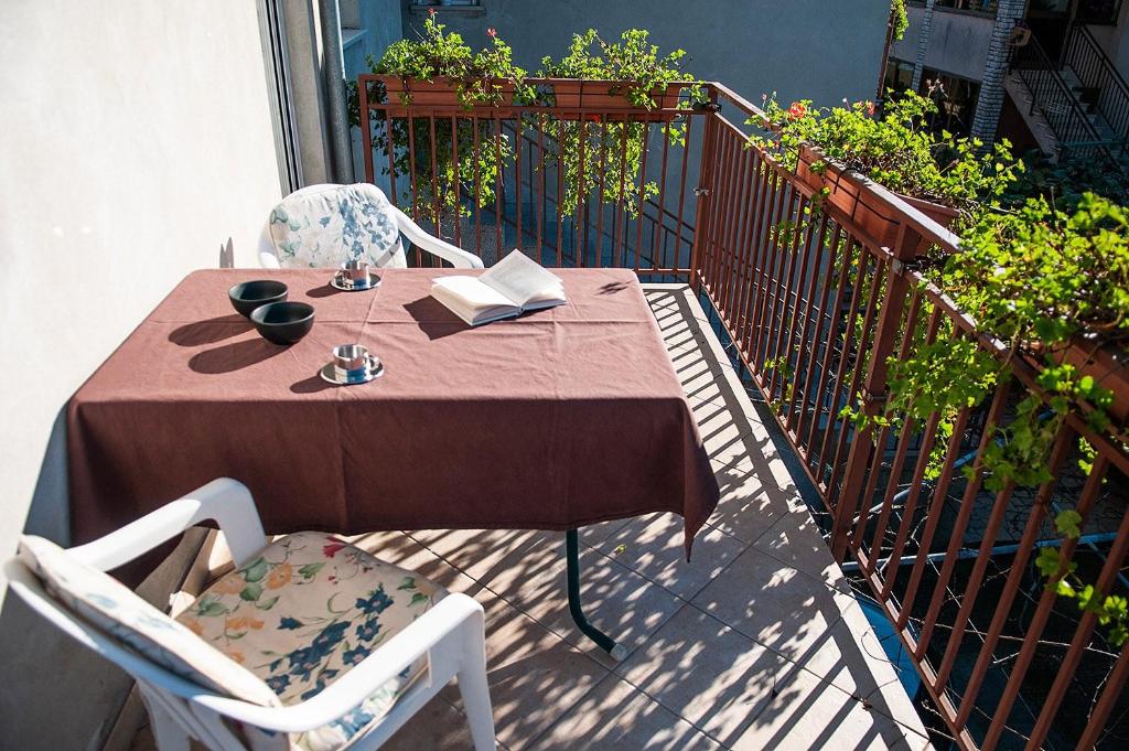 a table with two chairs and a book on a balcony at Apartment Anita in Pula