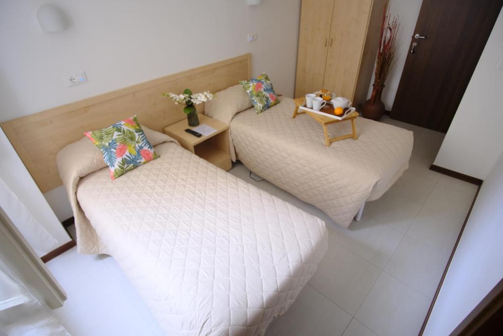 Postel nebo postele na pokoji v ubytování Hotel Milano