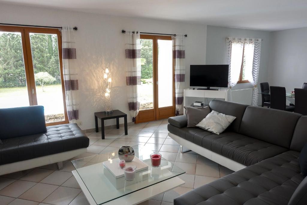 a living room with two couches and a tv at villa queen-south IT in Ventenac-Cabardès