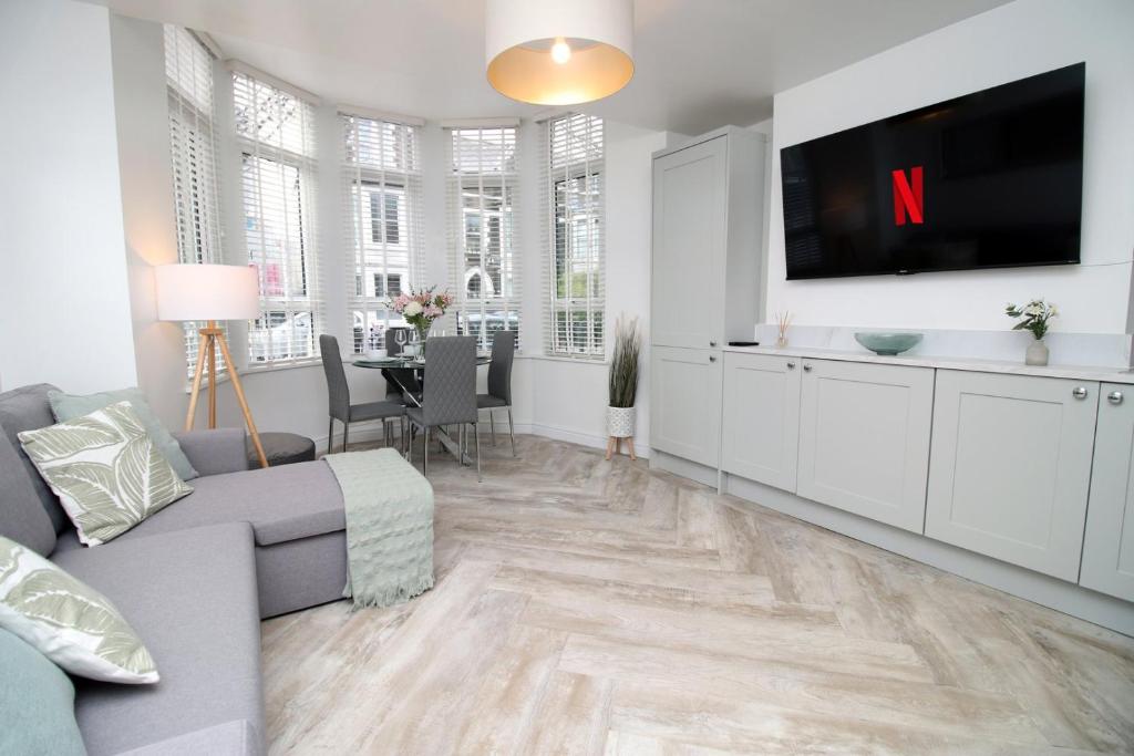 a living room with a couch and a tv at Luxury Apartment in Cardiff