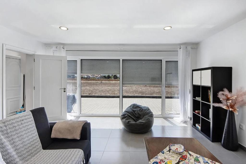 a living room with a couch and a table at MAISON DE VACANCES AVEIRO in Gafanha da Nazaré