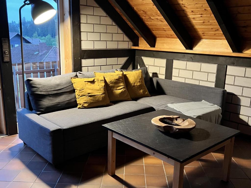 a living room with a couch and a table at Landhaus Reppel in Bad Laasphe