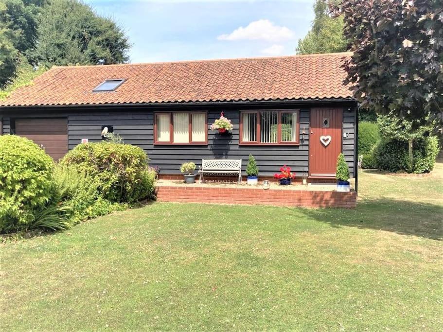 a small house with a bench in the yard at Owlhoot Annexe in Sudbury