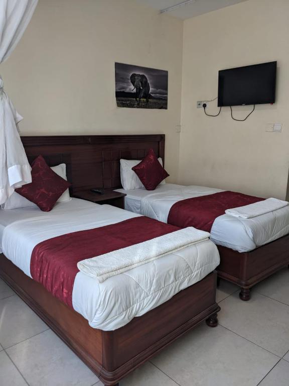 Postel nebo postele na pokoji v ubytování Epitome Times Hotel