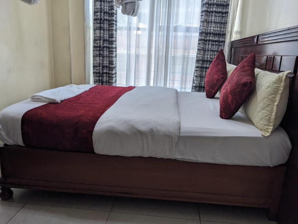 Postel nebo postele na pokoji v ubytování Epitome Times Hotel