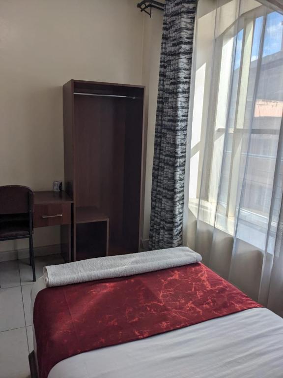 Postel nebo postele na pokoji v ubytování Epitome Times Hotel
