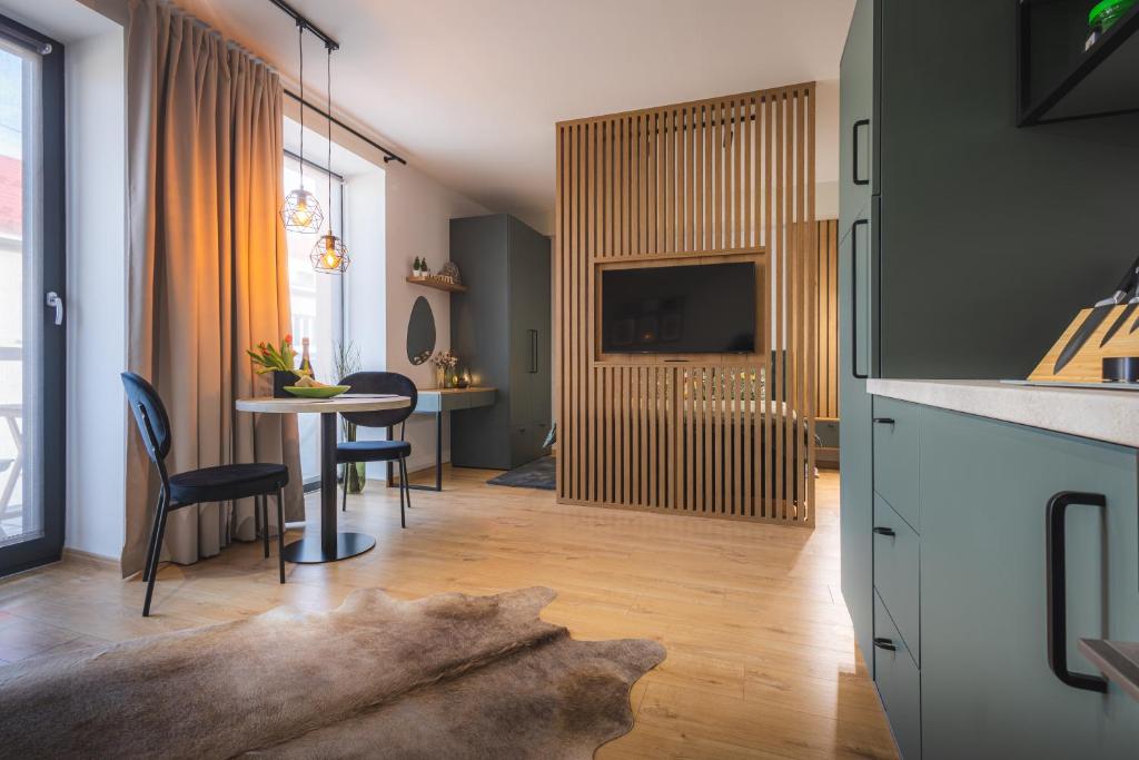 a kitchen and dining room with a table and chairs at GREEN APARTMENT in Banská Bystrica