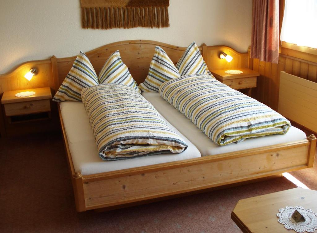 a couch with four pillows on it with two at Hotel Bahnhof in Reichenbach