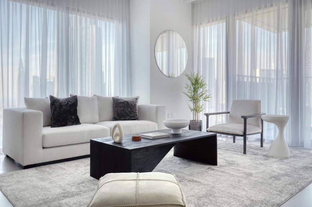 a living room with a white couch and a table at Luxury Apartment in Dubai in Dubai