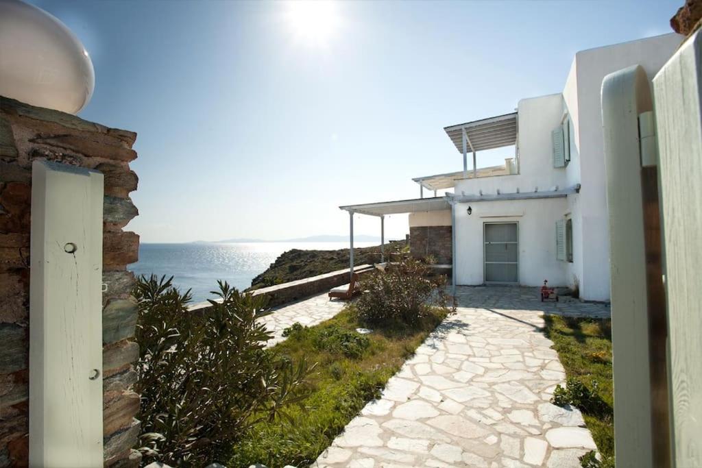 a white house with a view of the ocean at Sun Blooming Villa in Tinos island in Agios Romanos