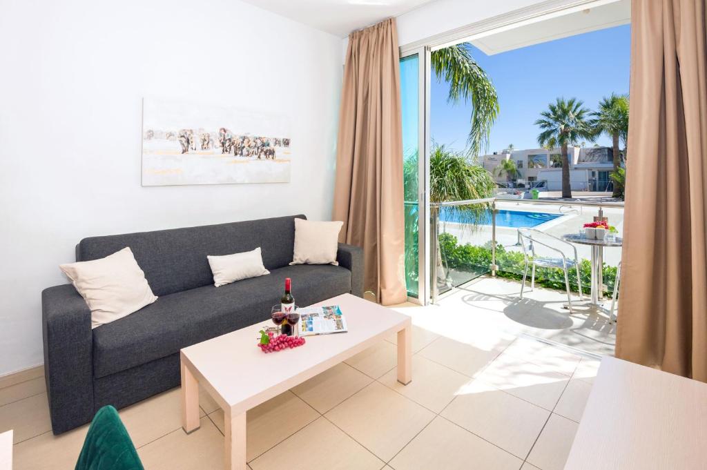 sala de estar con sofá y mesa en ALICIA - Beachfront Apartment, en Paralimni