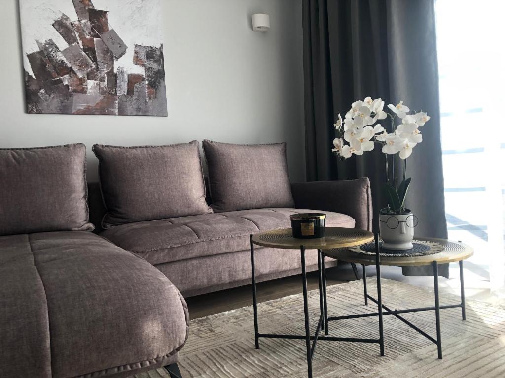a living room with a couch and two tables at Luxurious apartment in the heart of old town with parking in Kaunas