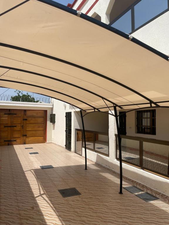 awning over a driveway of a house with a garage at Wendyla Luxury's in Bé