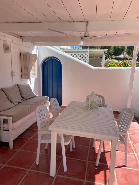 a patio with a table and chairs and a couch at RESIDENCE DAR YASMINa in Mezraya