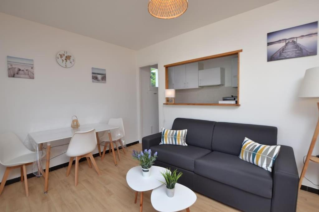 un salon avec un canapé et une table dans l'établissement Les plages du Boucanet, au Grau-du-Roi