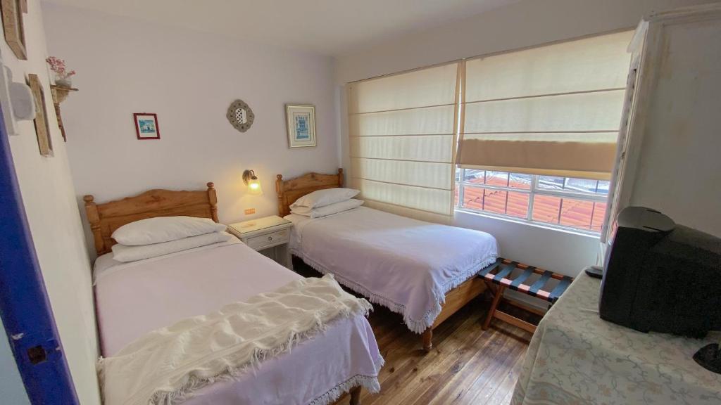 Postel nebo postele na pokoji v ubytování Sakti Hostal B&B