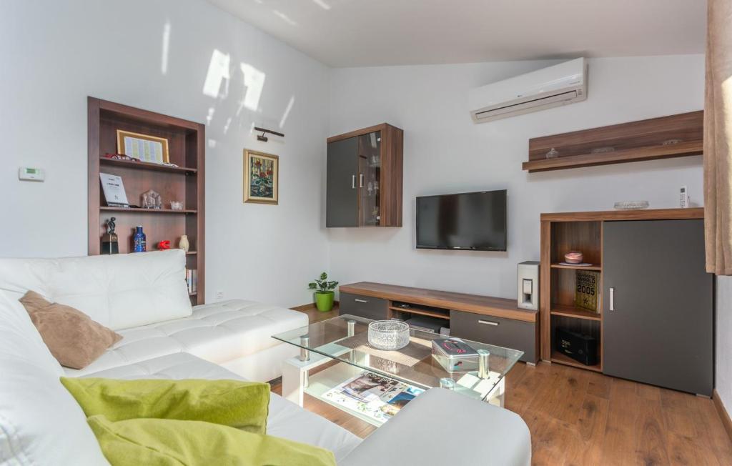 a living room with a white couch and a glass table at Apartment Valeria Vabriga in Vabriga