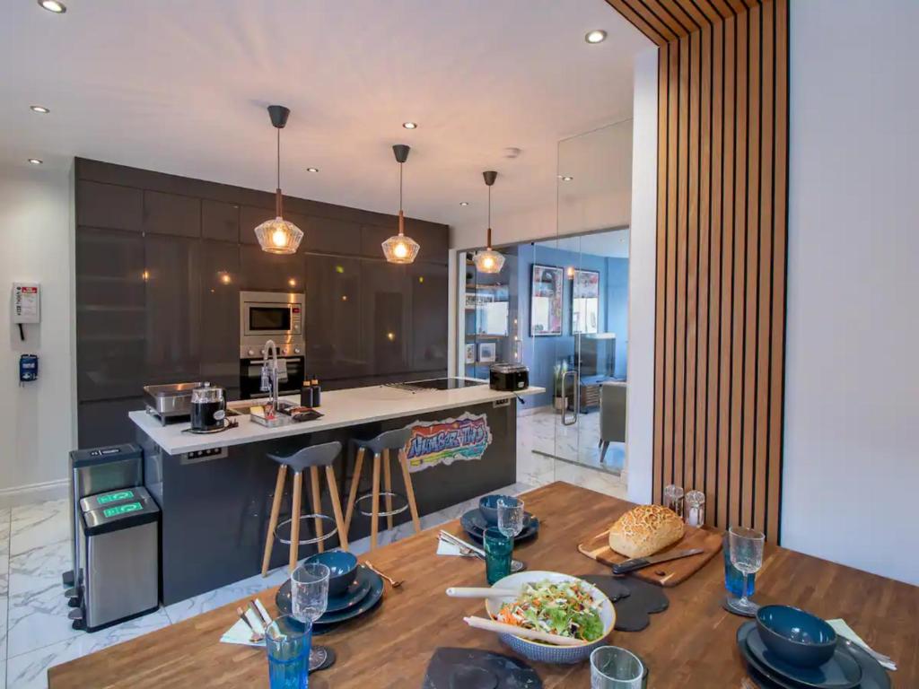 a kitchen and living room with a table with food on it at Pass the Keys Bespoke Coastal Retreat Whitley Bay in Whitley Bay
