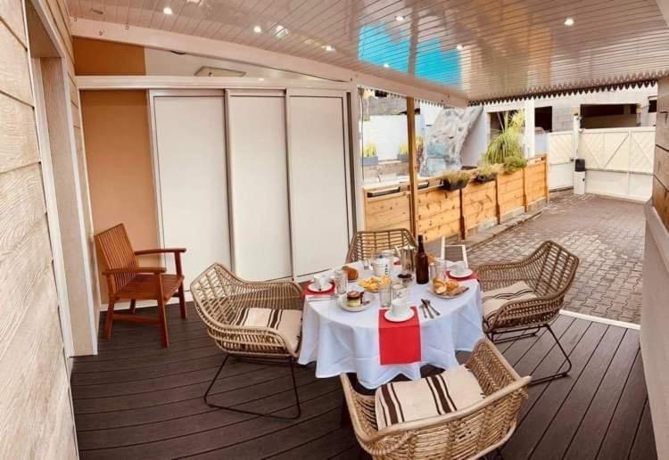 a dining table and chairs on a deck of a yacht at Chez Arlette in Saint-Louis