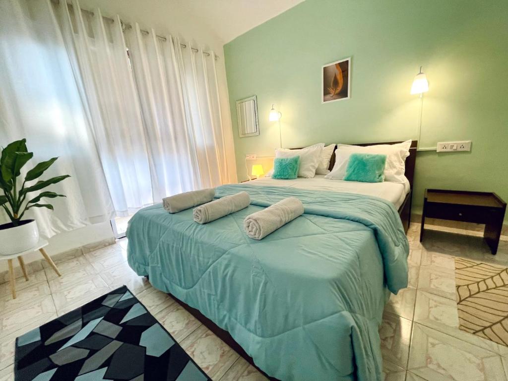 a bedroom with a large bed with two pillows on it at Luxurious 2 BHK Villa AniRah Homes 2 minutes to beach in Colva