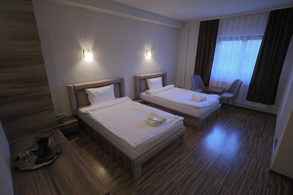 Postel nebo postele na pokoji v ubytování Hotel Denis