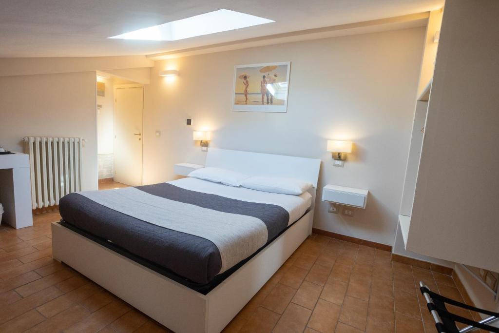 een slaapkamer met een groot bed in een kamer bij Helios Assisi in Assisi