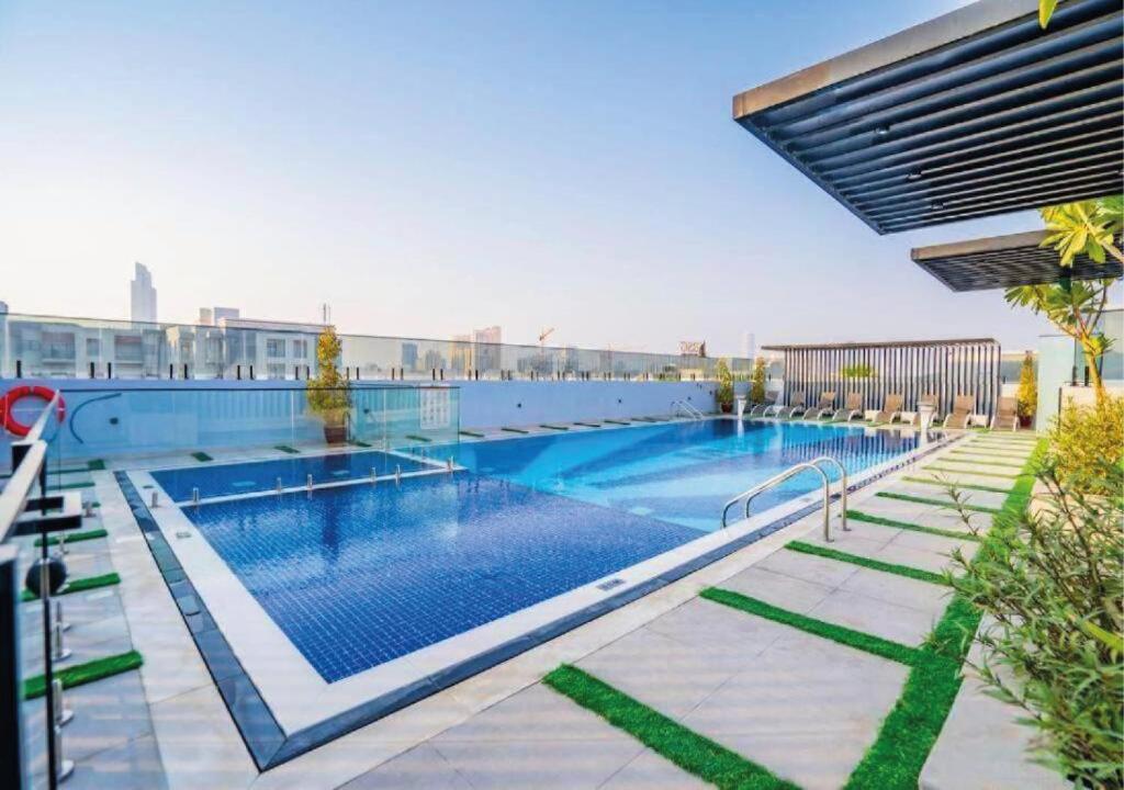 a large swimming pool on top of a building at OMO! Insane Deal! Studio near Me'aisem City Center in Dubai