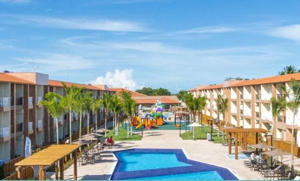a resort with a swimming pool and a playground at Ondas Praia Resort in Porto Seguro