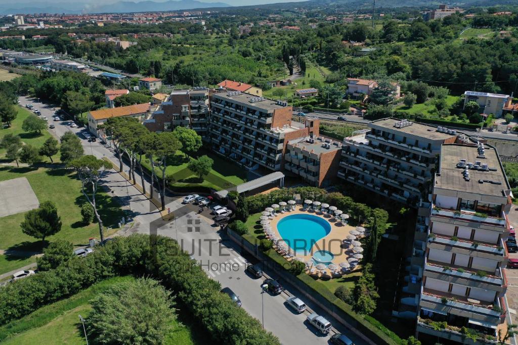 an aerial view of an apartment building with a pool at Home Away Livorno - Suite Livorno Holiday Home Group in Livorno