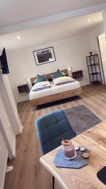 a large living room with a bed and a table at Heimatliebe Erfweiler Wohnung VIER in Erfweiler
