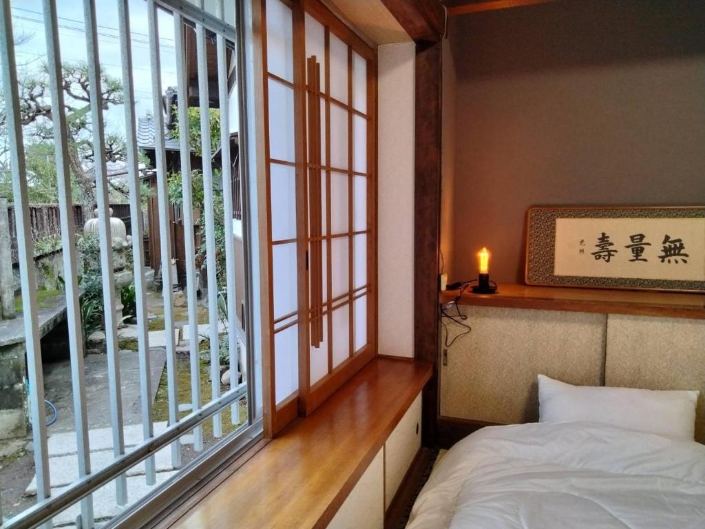 Postel nebo postele na pokoji v ubytování Guesthouse Sakichi