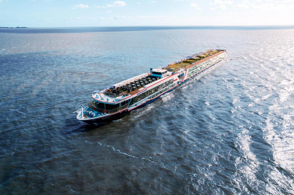 a boat in the water with people on it at KD Moment Premium Hotelship Köln in Cologne