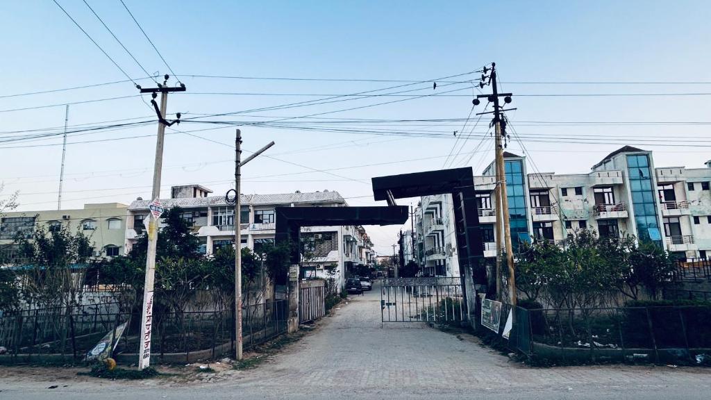 an open gate in front of some buildings at Jadoon Homestay near Prem Mandir in Vrindāvan
