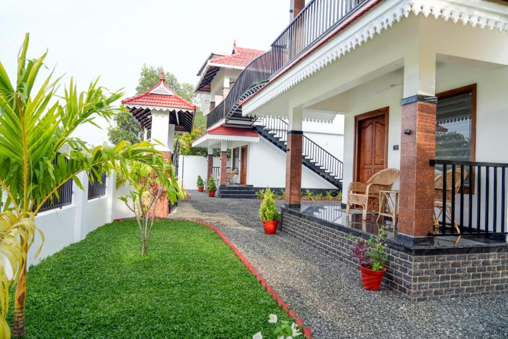 a house with a garden in front of it at Coconut Palms Village Homestay in Kumarakom