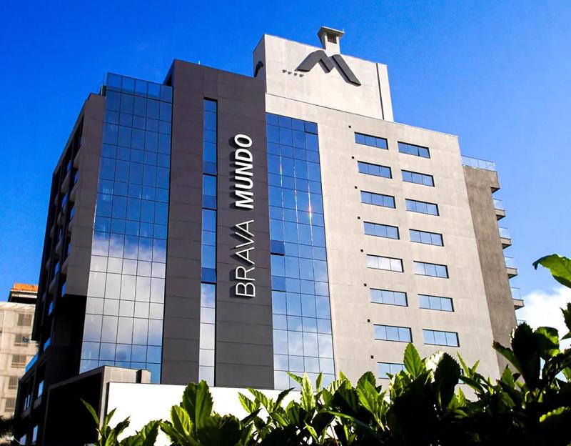 a tall building with a sign on top of it at Brava Mundo Hotel Boutique in Itajaí