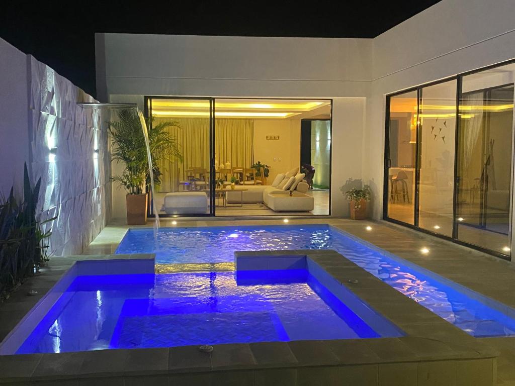 a swimming pool with blue lights in a house at Casa kalumaye ibague in Ibagué