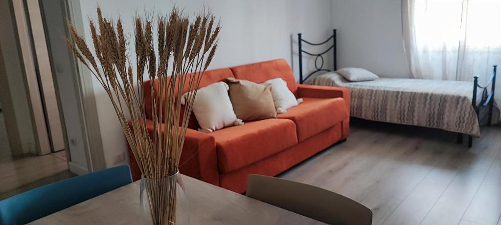 a living room with an orange couch and a table at Casa Angelina in Rome