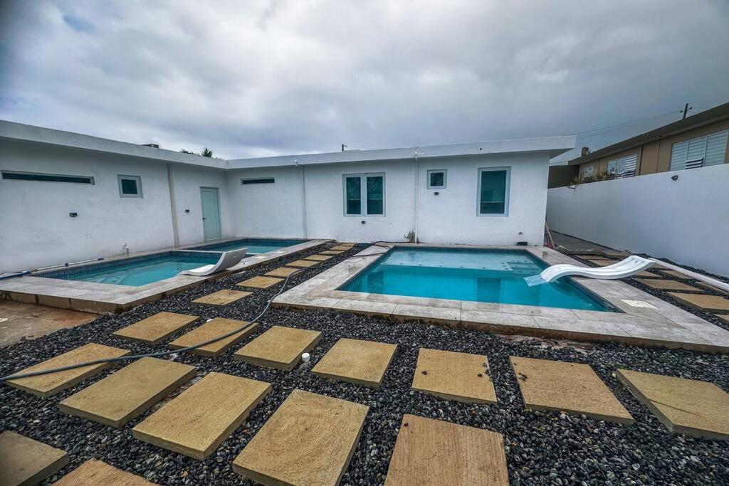 a swimming pool in the backyard of a building at Centrally located Villa with 3 Pools -Food & Beach walking distance in Arecibo