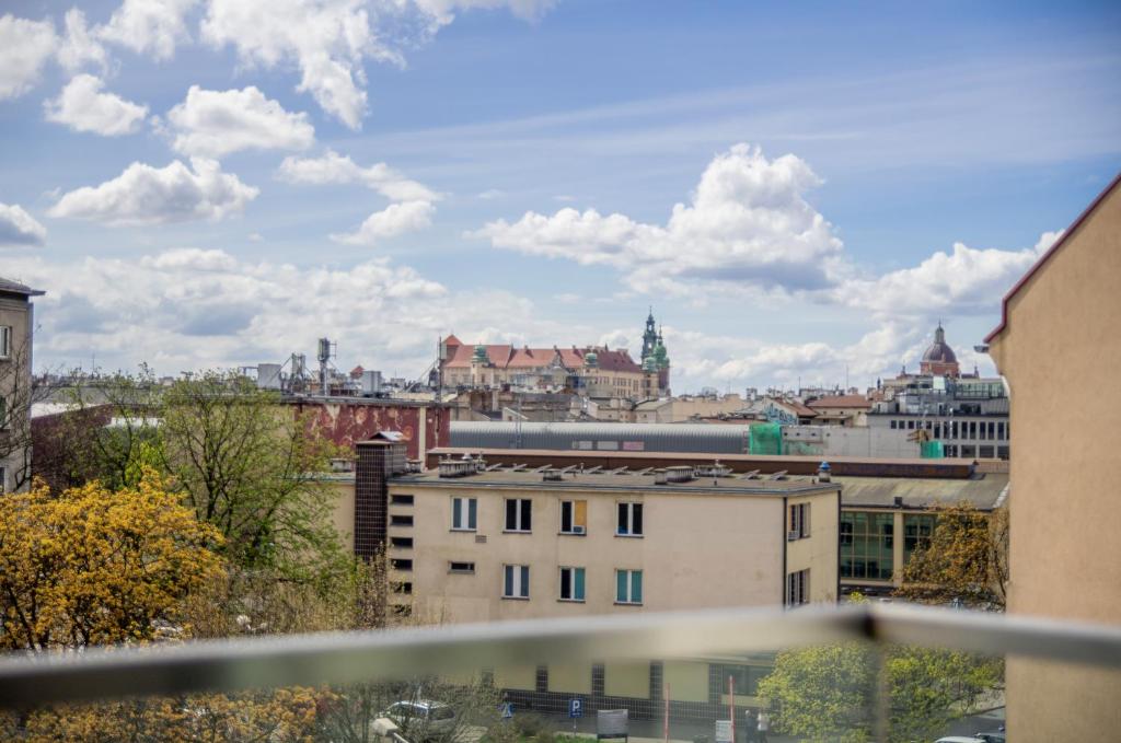 a view of a city from a balcony at InPoint Aparthotel Grzegórzecka 11 in Kraków