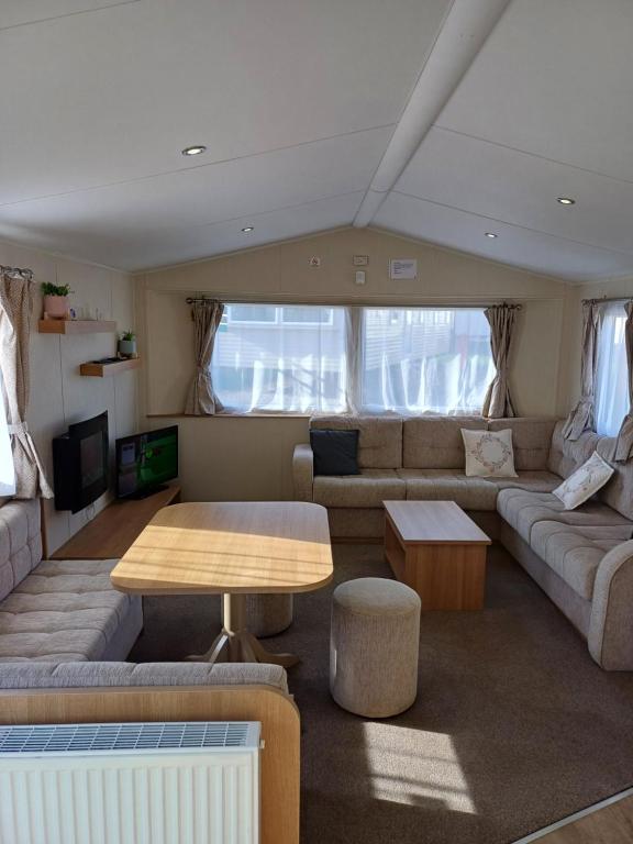 a living room with a couch and a table at Caravan Holiday Home @ Marton Mere, BLACKPOOL in Blackpool